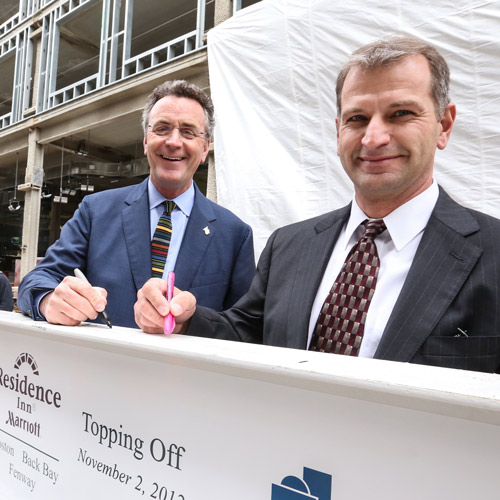 Bill McQuillan and Mark Deschenes standing in front of the construction site for Marriott Residence Inn Fenway